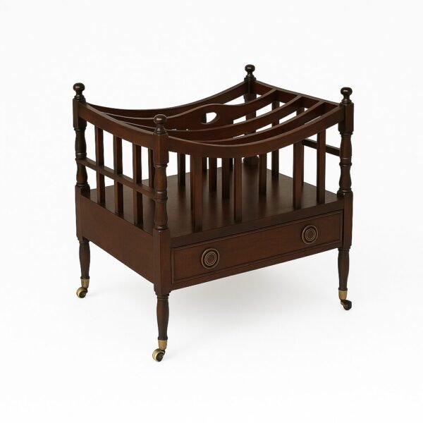 A classic mahogany magazine rack with spindles, curved top rails, and a lower drawer on rolling caster legs.