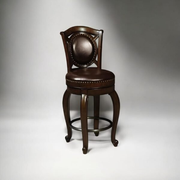 Elegant classic bar stool with round leather backrest, crafted from solid mahogany wood in rich dark brown finish, featuring hand-polished cabriole legs, full leather padded seat with antique brass nailhead trim, and a sturdy circular metal footrest—perfect for traditional home bars, luxury villas, and vintage-style hospitality interiors. Designed for export to Germany, France, UK, and the Middle East, this antique wooden bar chair reflects timeless craftsmanship and premium Indonesian furniture artistry.
