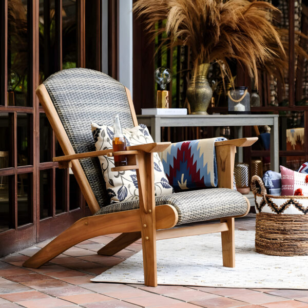 Handwoven wooden lounge chair with rattan details and patterned cushions, made by Indonesia furniture manufacturer.