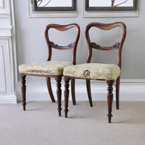 Pair of retro Victorian-style balloon back chairs with beige floral upholstery and carved wooden frames -- Indonesia Furniture